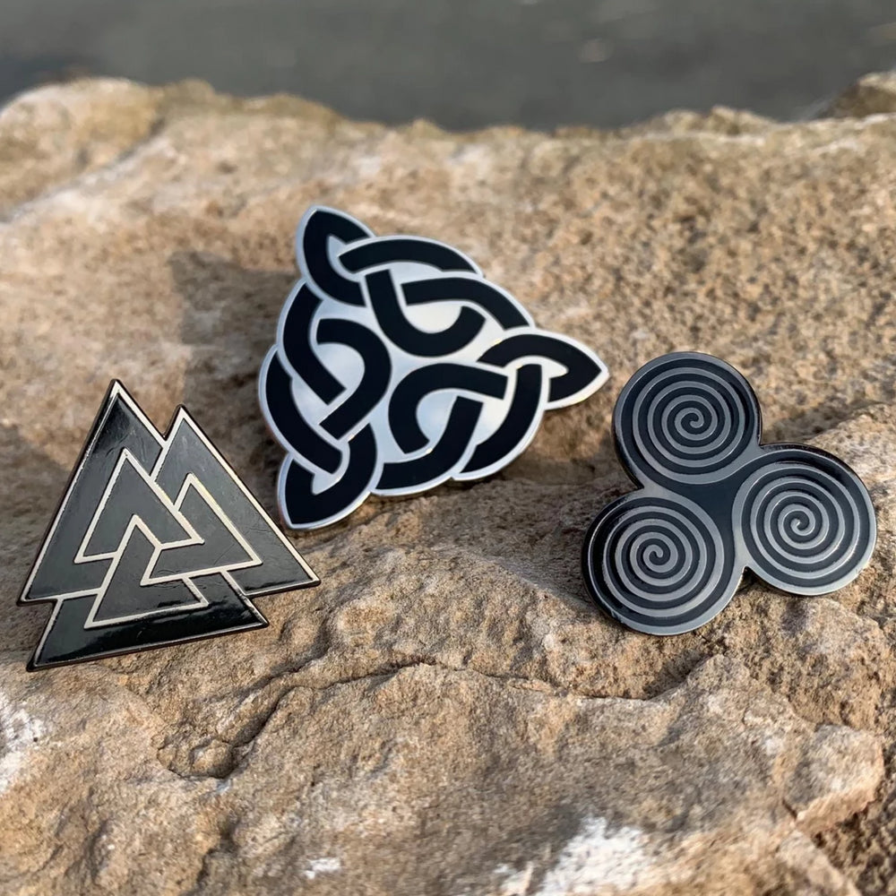 Sacred Knot enamel pin series designed by Sean Parry for Northern Fire Designs. Mixture of celtic and nordic art including: Sacred Knot Logo, Valknut and Triskel