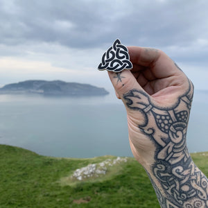 
                
                    Load image into Gallery viewer, Sacred Knot Enamel Pin, pictured in Llandudno
                
            