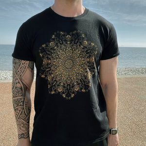 
                
                    Load image into Gallery viewer, Mandala design inspired by the Viking Age printed in gold on a black shirt designed by Sacred Knot Tattoo
                
            